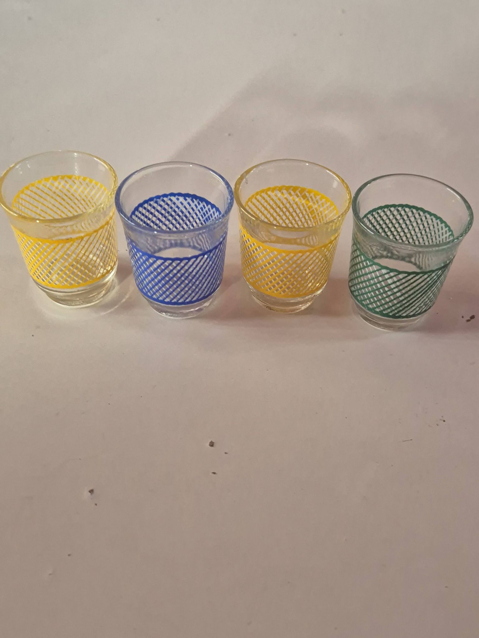 set of 4 vintage liqueur glasses in yellow, green, and blue
