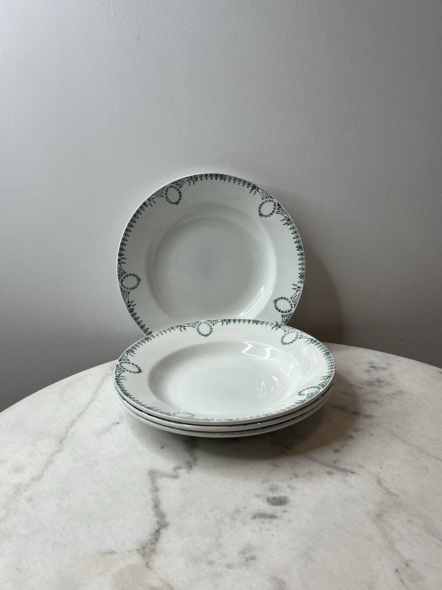 Set of 4 deep plates from Saint Amand with laurel wreath decoration.