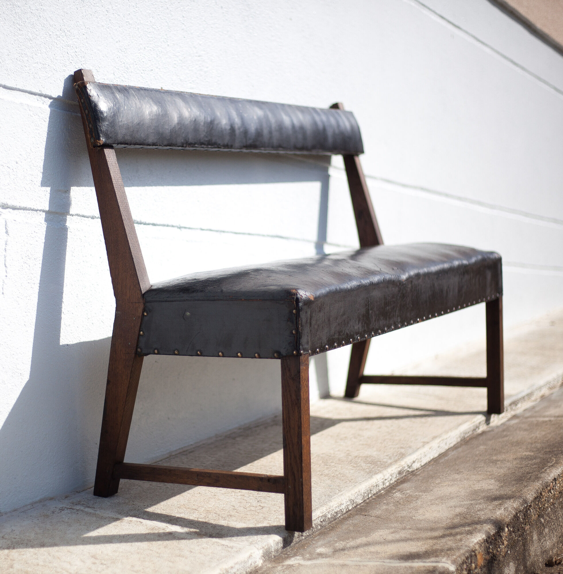 Antique wood bench and black imitation leather