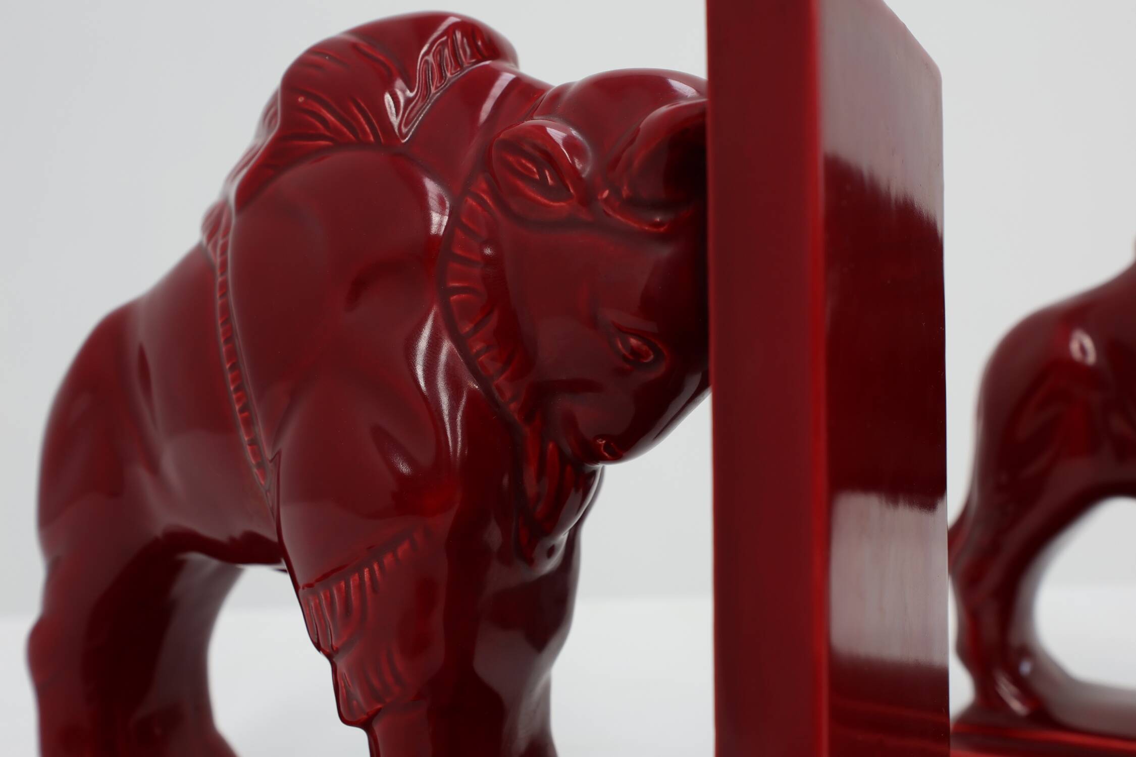 Pair of red glazed ceramic Bison ox bookends in Art Deco style, Belgium