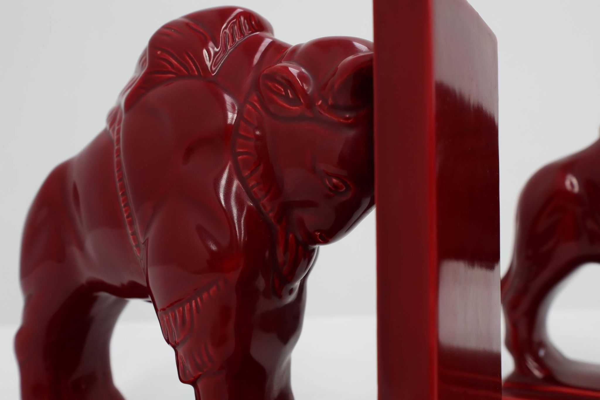 Pair of red glazed ceramic Bison ox bookends in Art Deco style, Belgium