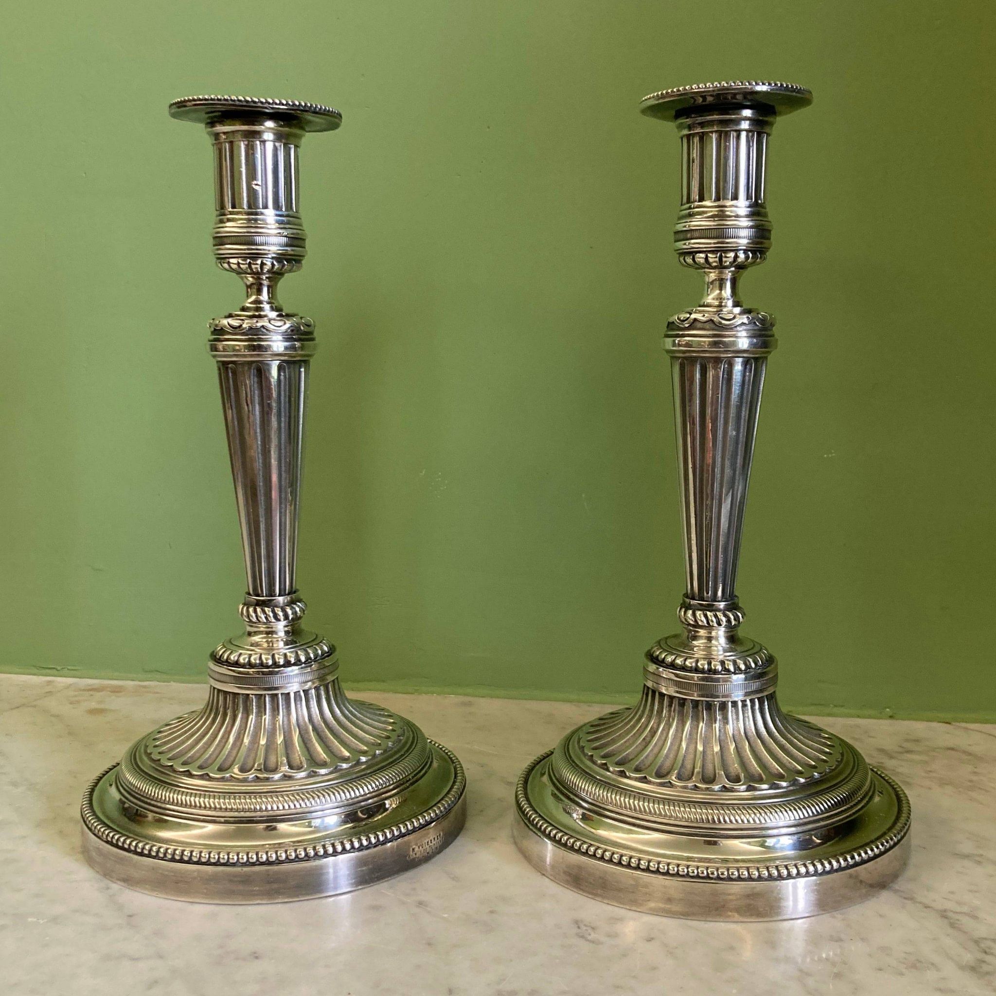 Pair of silvered bronze candlesticks in the Louis XVI style signed Voisenet, 19th century.