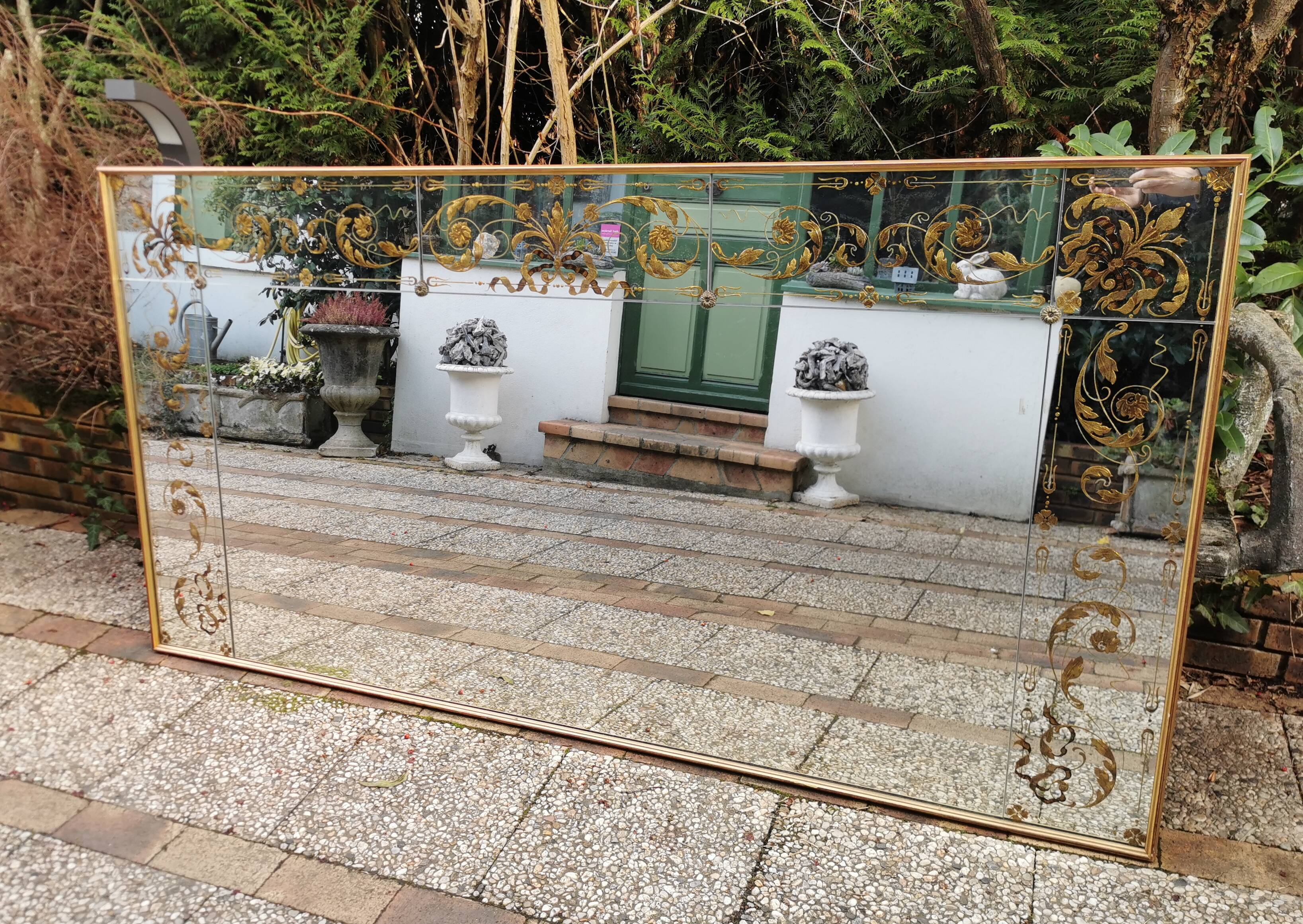 Glass mirror with a decoration engraved with golden foliage 1960