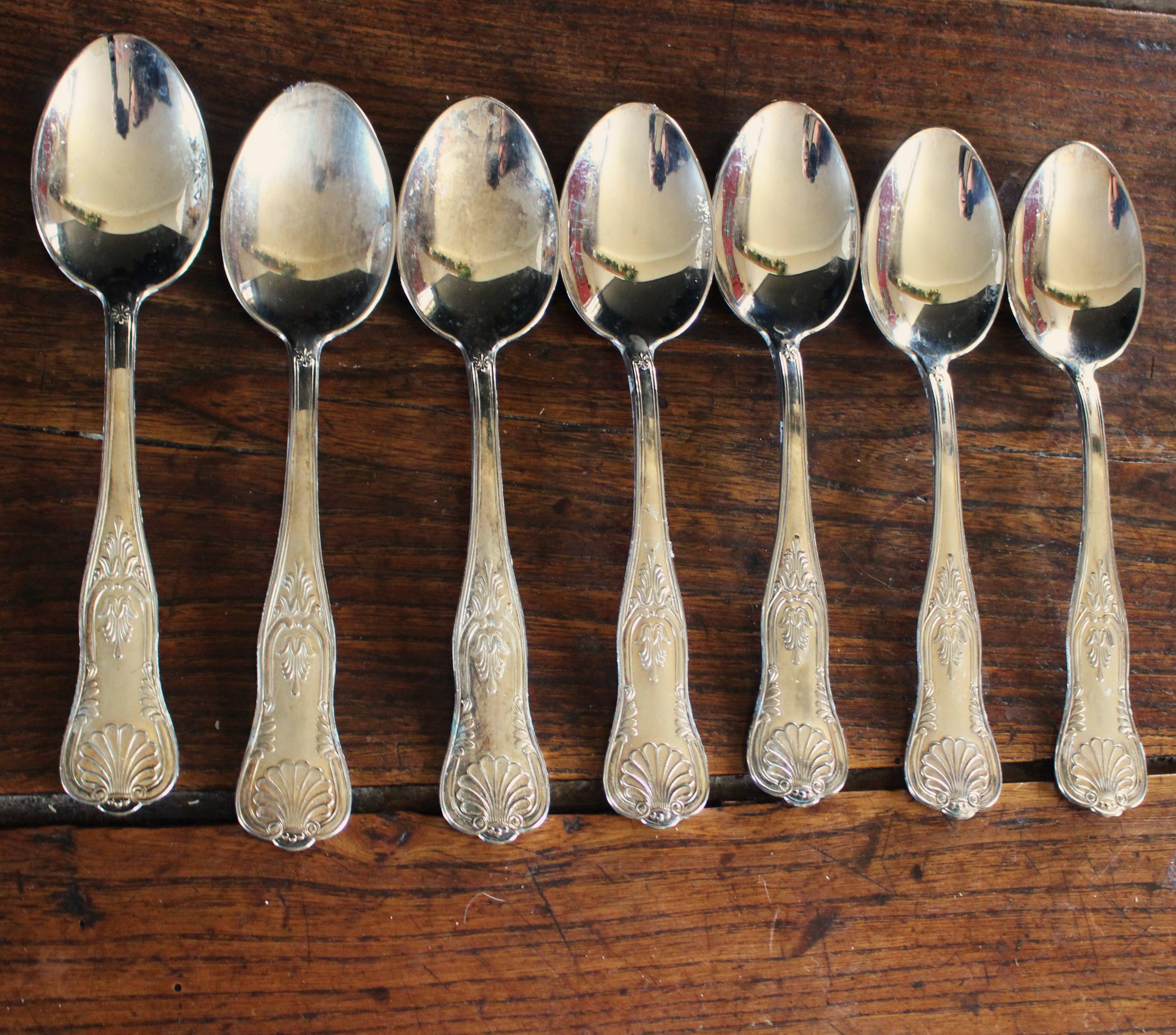 A set of 7 large metal shell spoons