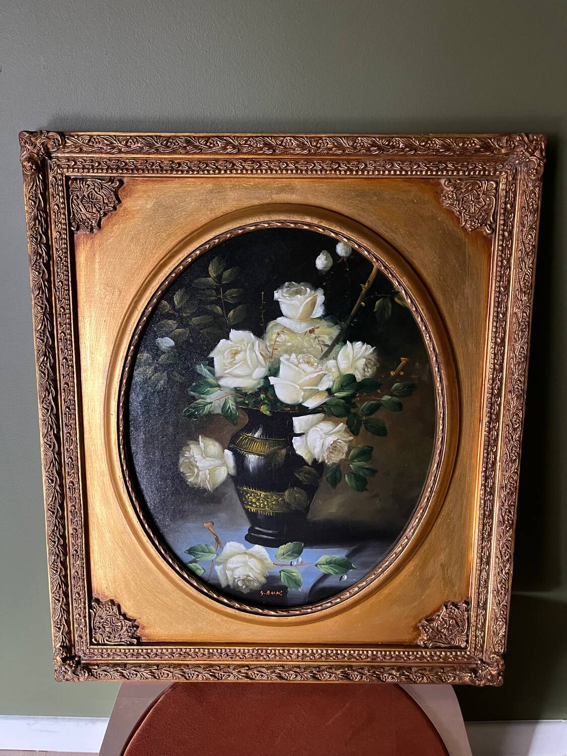 Large still life with white roses in an old gilded oval frame.