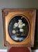 Large still life with white roses in an old gilded oval frame.