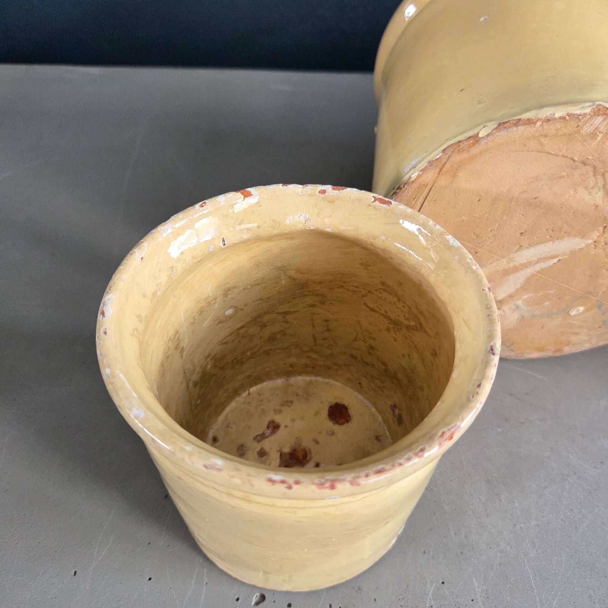 Trio of ancient pots in yellow glazed terracotta.