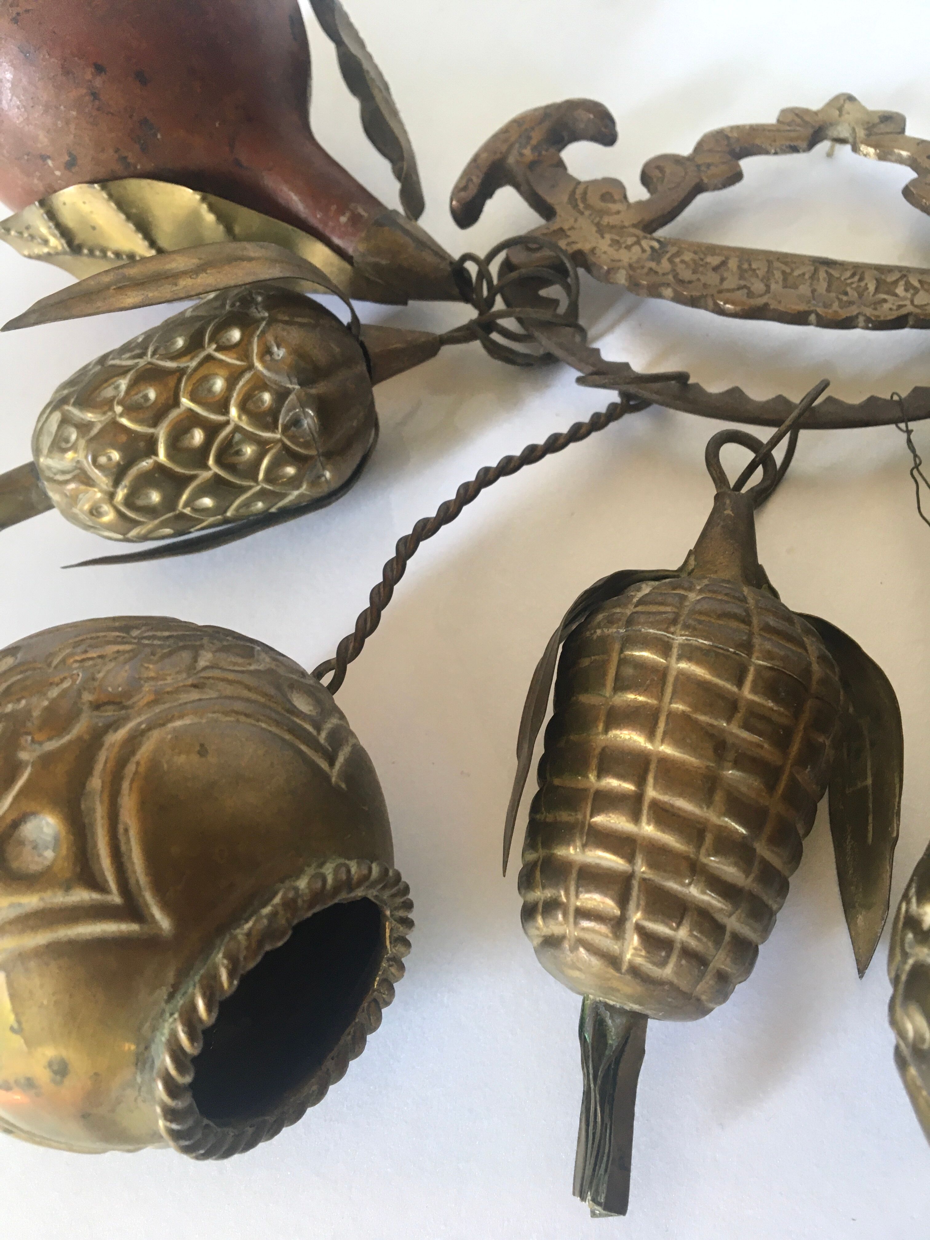 Wall decoration of brass and wood amulets