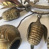 Wall decoration of brass and wood amulets