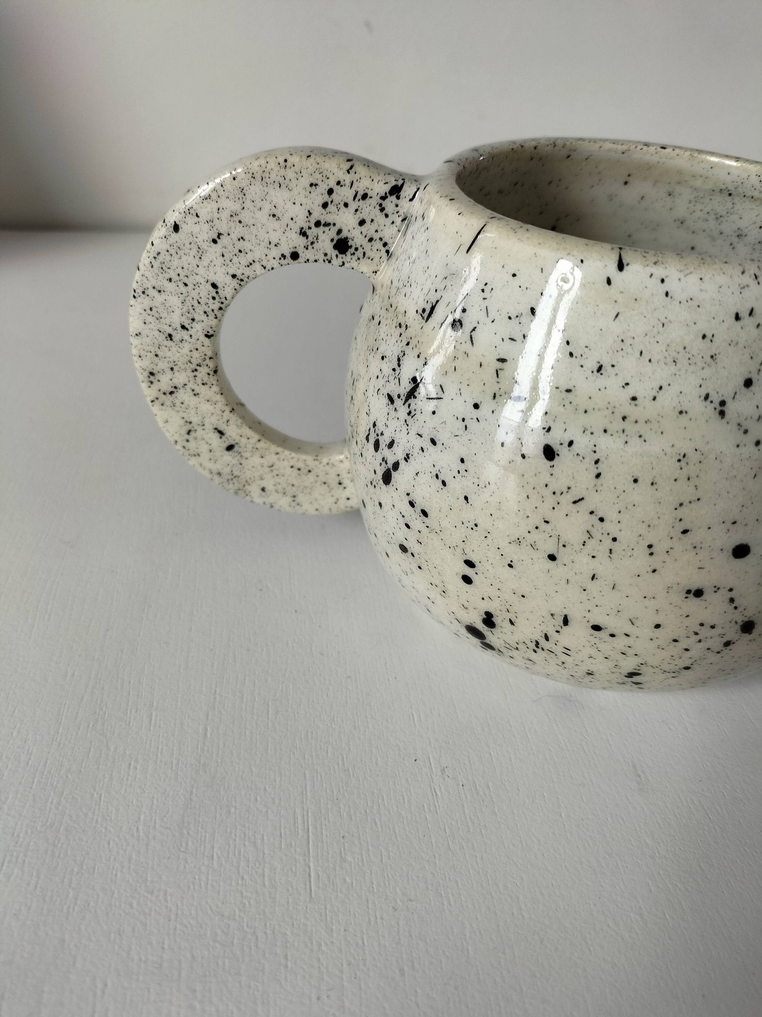 Small speckled ceramic jug in a vintage workshop style.