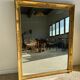 Miroir doré style Restauration à décor de palmettes étirées