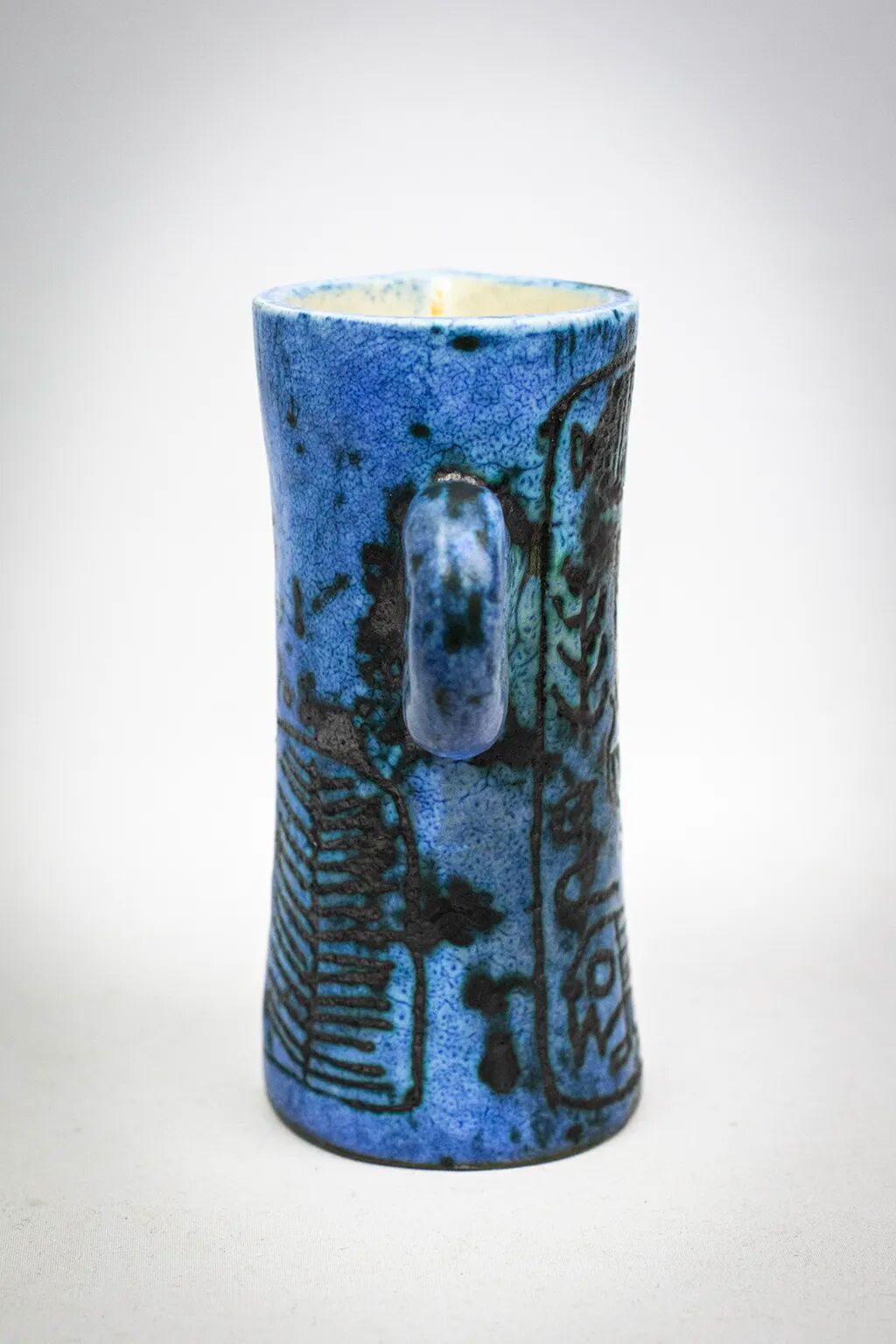 Small jug by Jacques Blin in blue ceramic with engraved animal decoration.