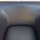 2 club armchairs with a chocolate faux leather seat and backrest and wooden legs.