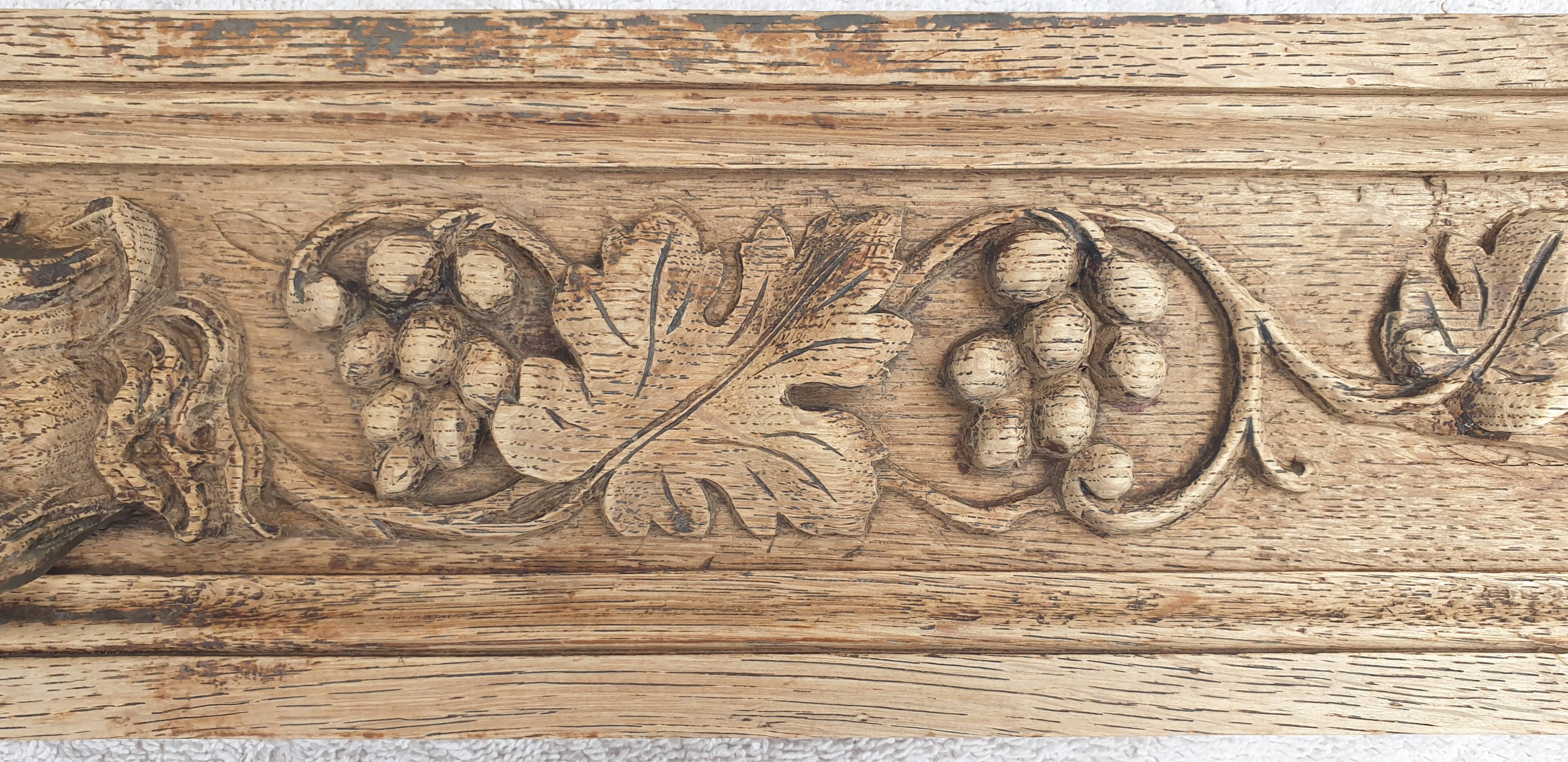 Natural wood pediment with bunches of grapes