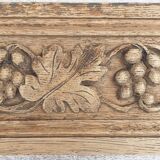 Natural wood pediment with bunches of grapes