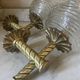 Pair of neoclassical wall sconces in twisted brass and ribbed glass.