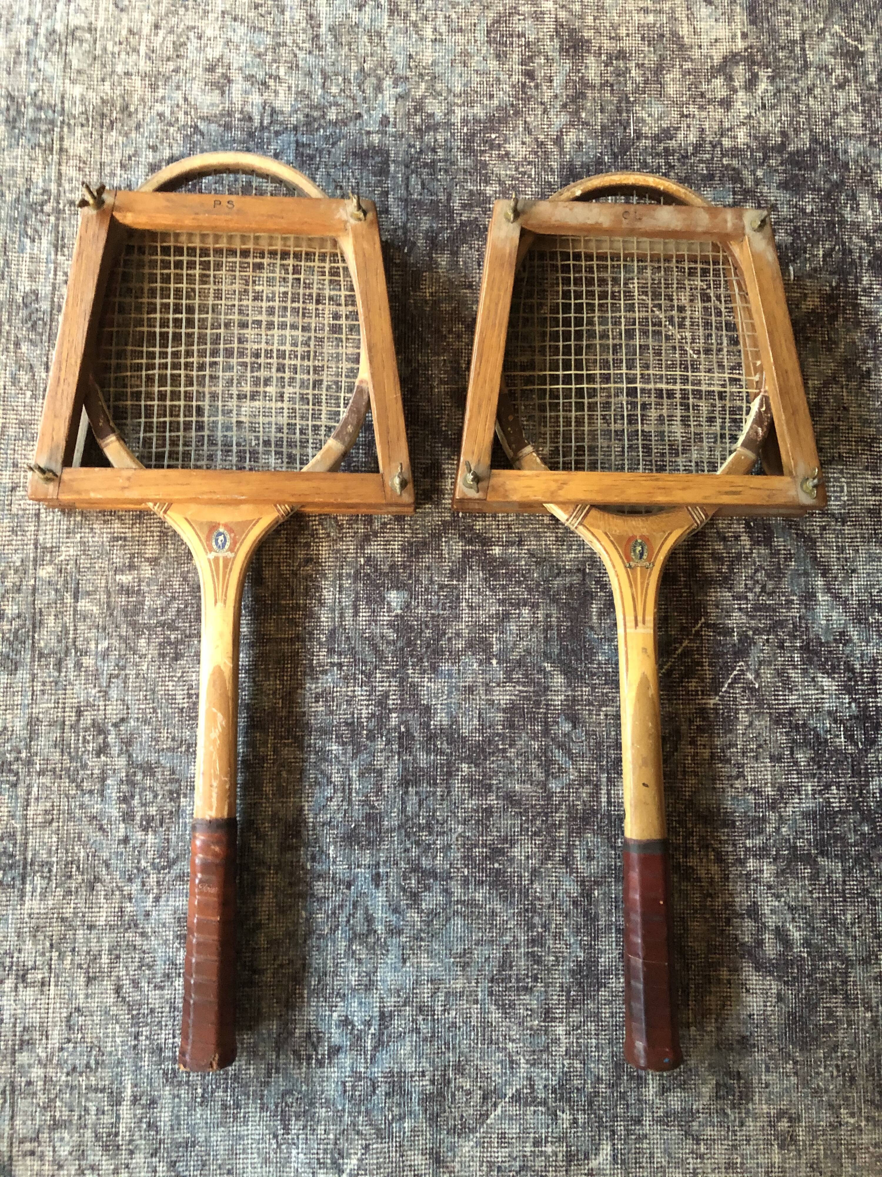 Pair of old wooden tennis rackets with 50s frames