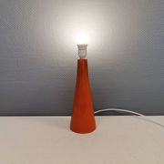 Ceramic table lamp with partial orange glaze.
