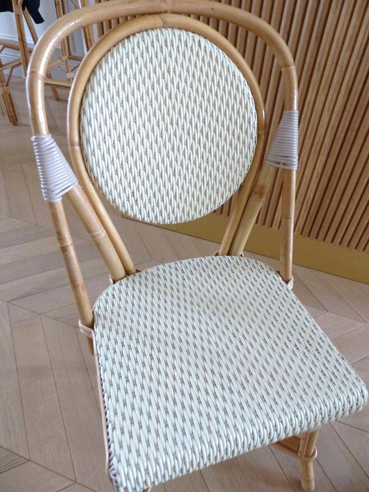 Pair of Parisian bistro chairs from Maison Louis Drucker in light Manila rattan.