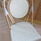 Pair of Parisian bistro chairs from Maison Louis Drucker in light Manila rattan.