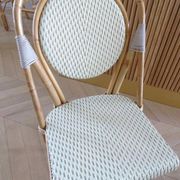 Pair of Parisian bistro chairs from Maison Louis Drucker in light Manila rattan.