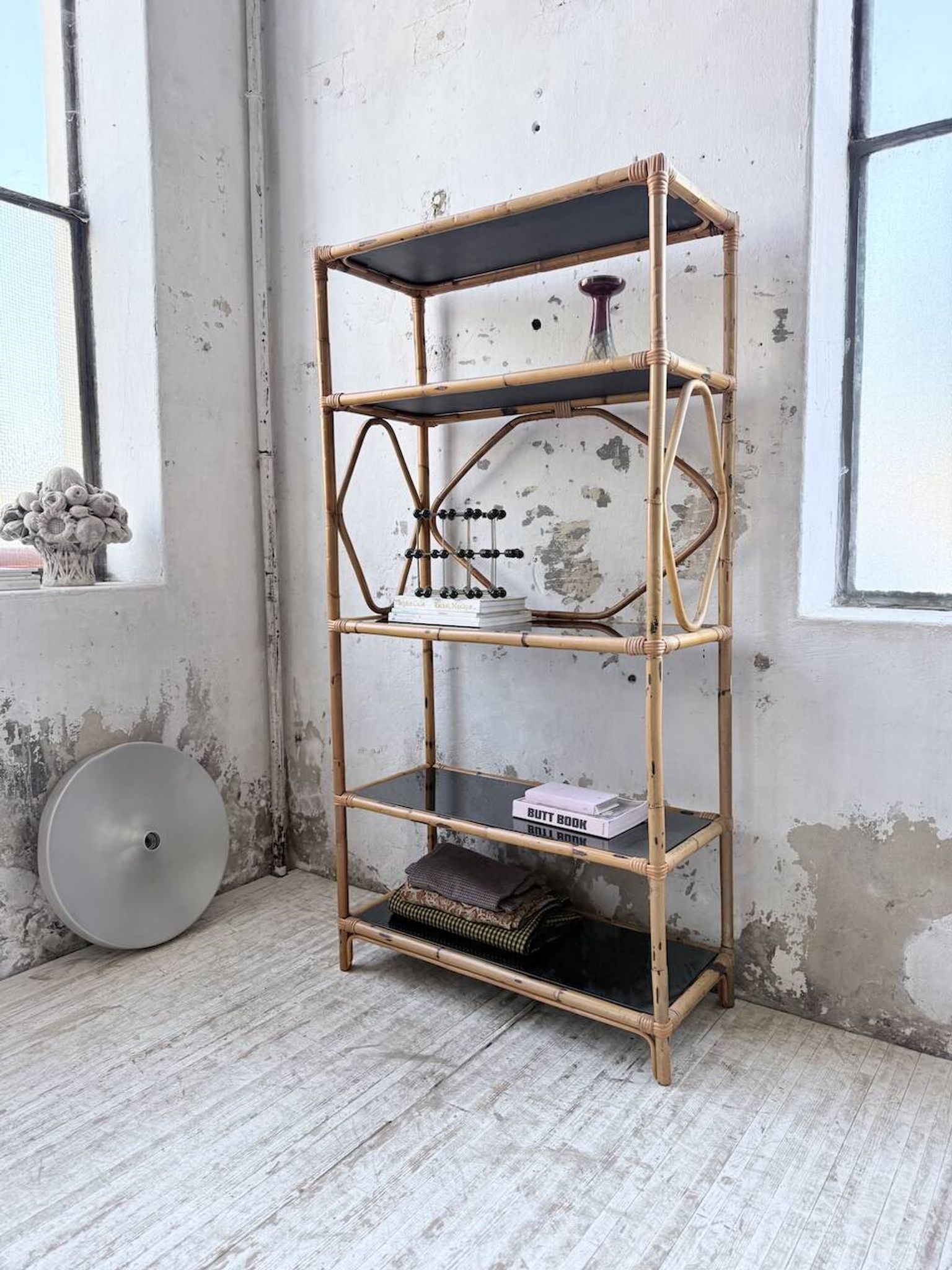 Rattan bookshelf and black glasses