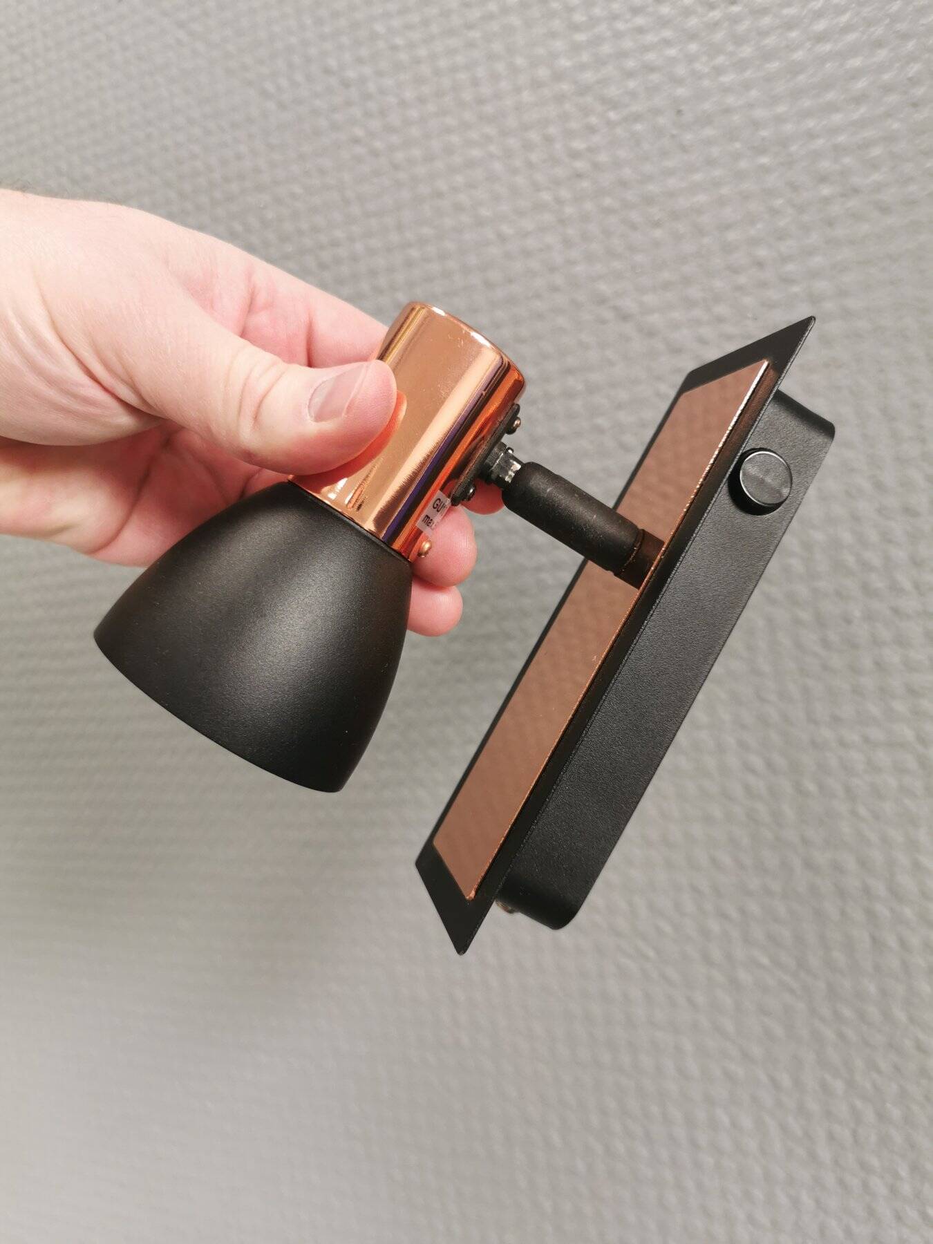 A pair of wall lamps from Eglo, in copper color and black.