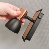 A pair of wall lamps from Eglo, in copper color and black.