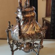 Ancient samovar tea fountain in silver metal