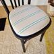 Curved black wooden bistro chair with striped seat