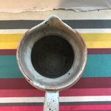 Old gray pitcher with black drawings and vintage stamped handle