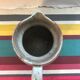 Old gray pitcher with black drawings and vintage stamped handle