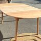 Large round family table with 2 extensions in solid raw wood.