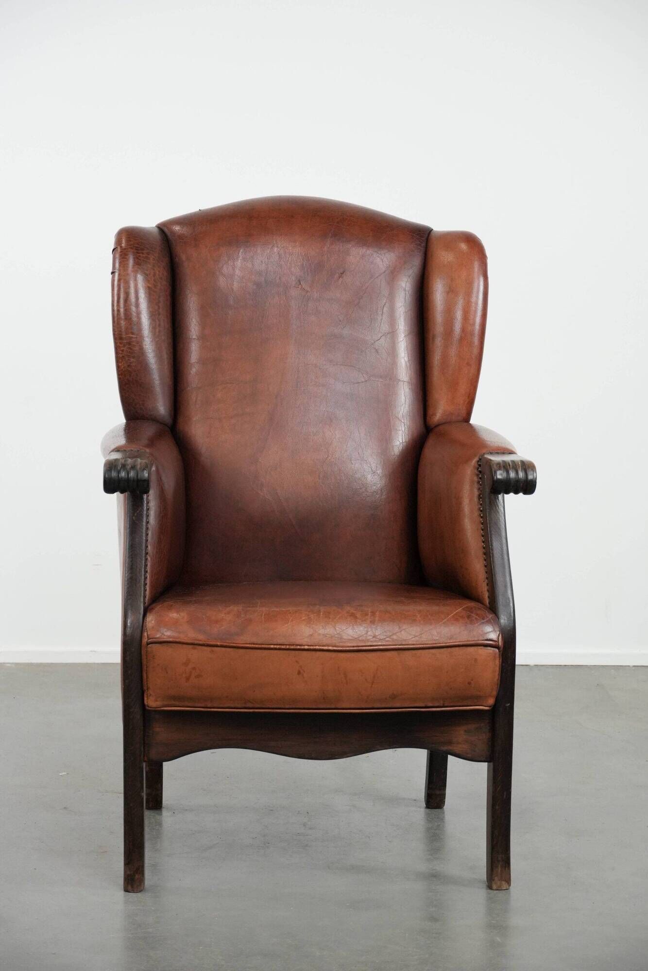 Classic vintage wingback chair in sheepskin and wood