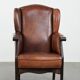 Classic vintage wingback chair in sheepskin and wood