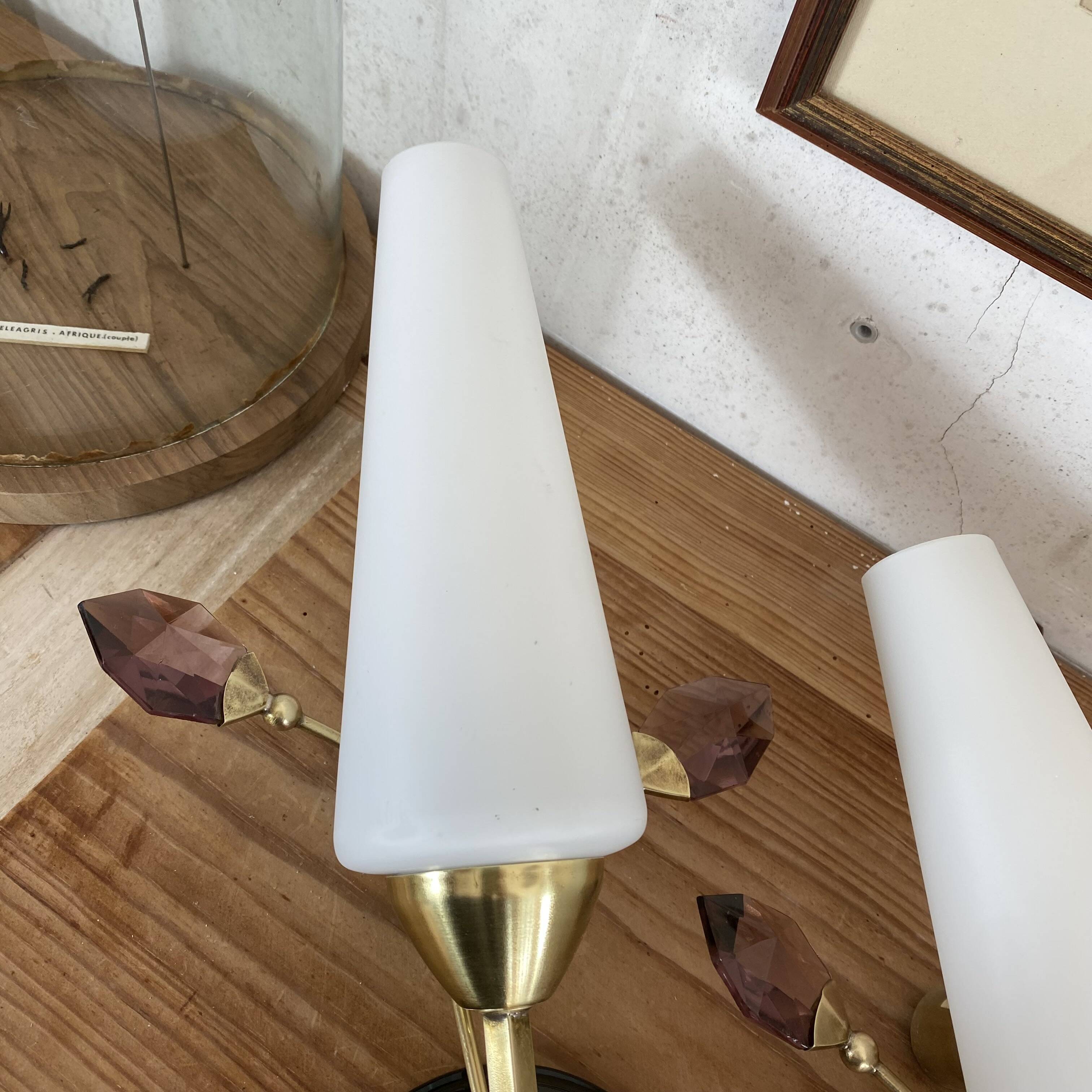 Pair of wall sconces in brass with white glass tulips.