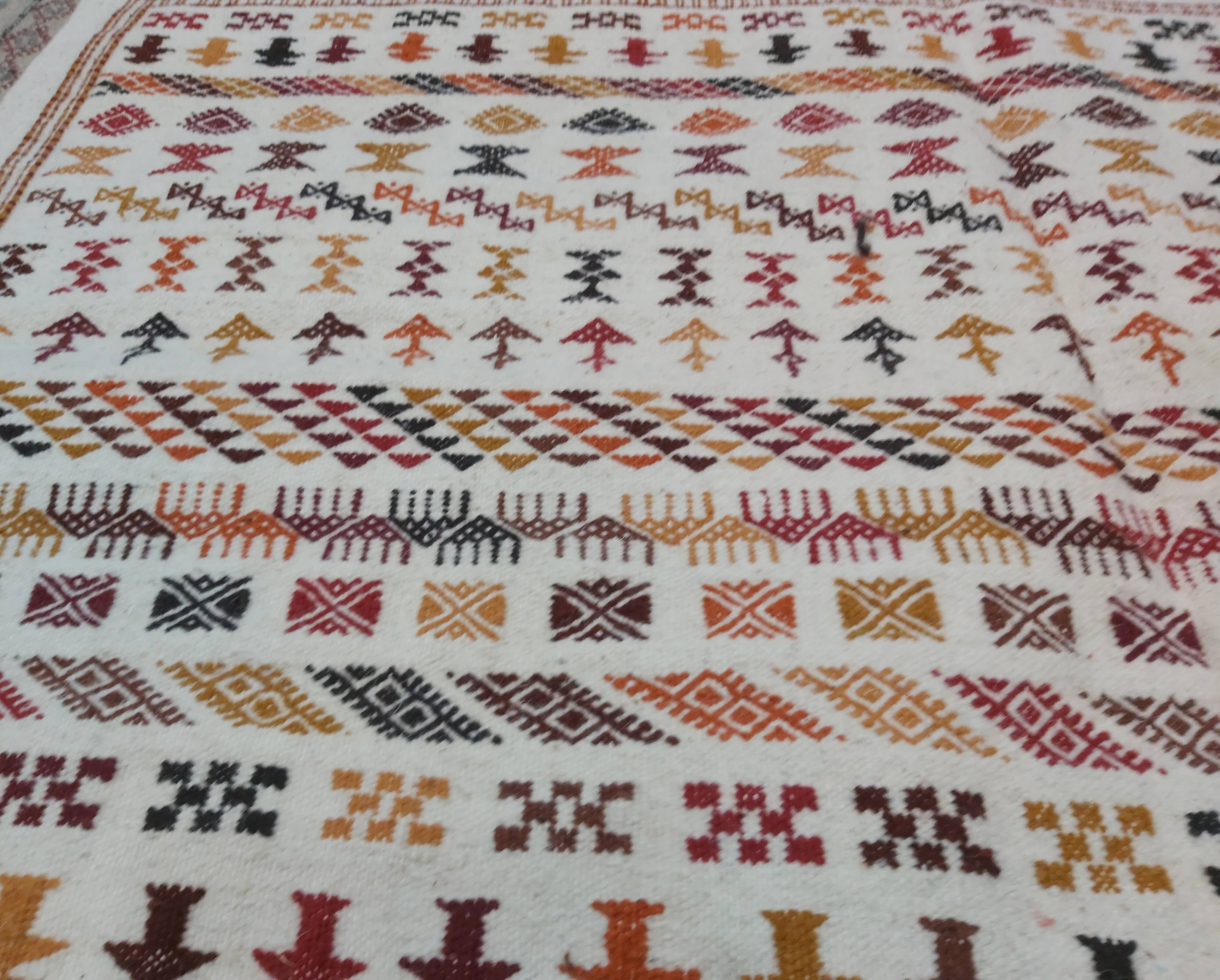 White carpet with multicolored Berber patterns