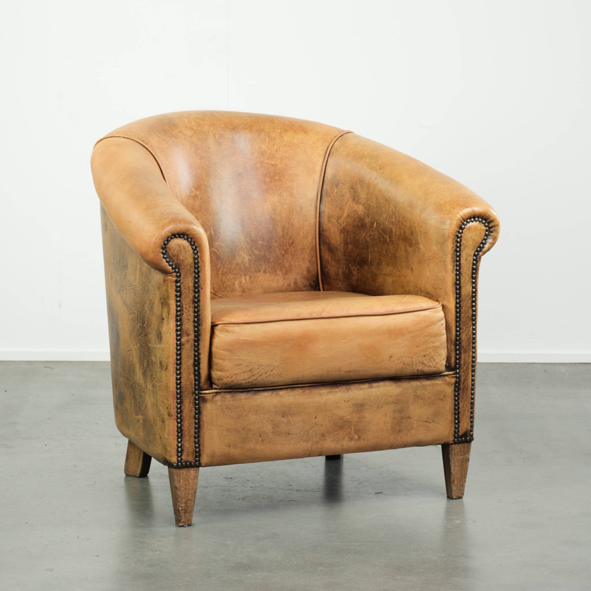 Vintage sheepskin club armchair in a light cognac colour
