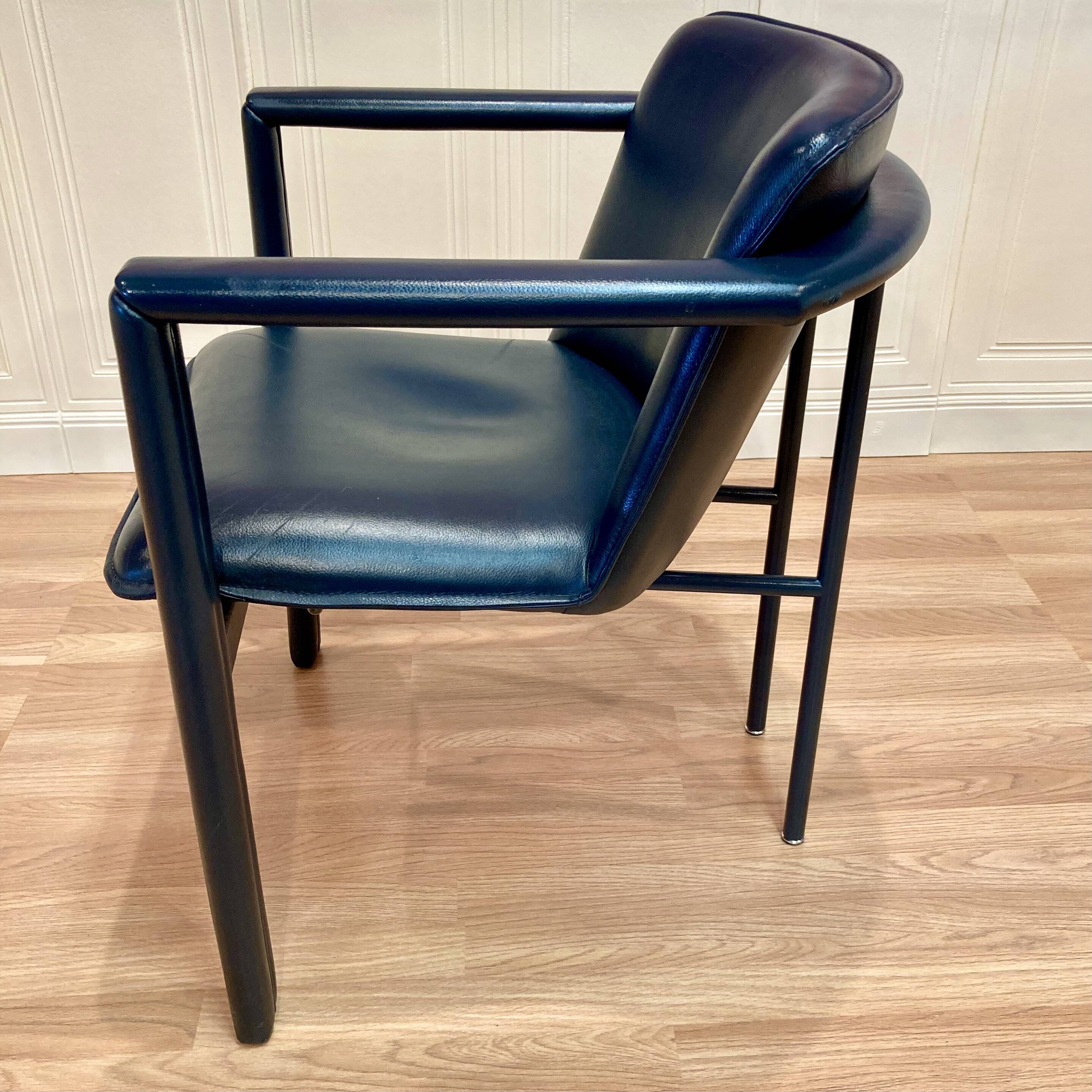 Design armchair in leather and metal.