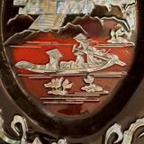 Marquetes lacquer dish with mother-of-pearl inlays figuring 3 characters on a boat in front of a temple.