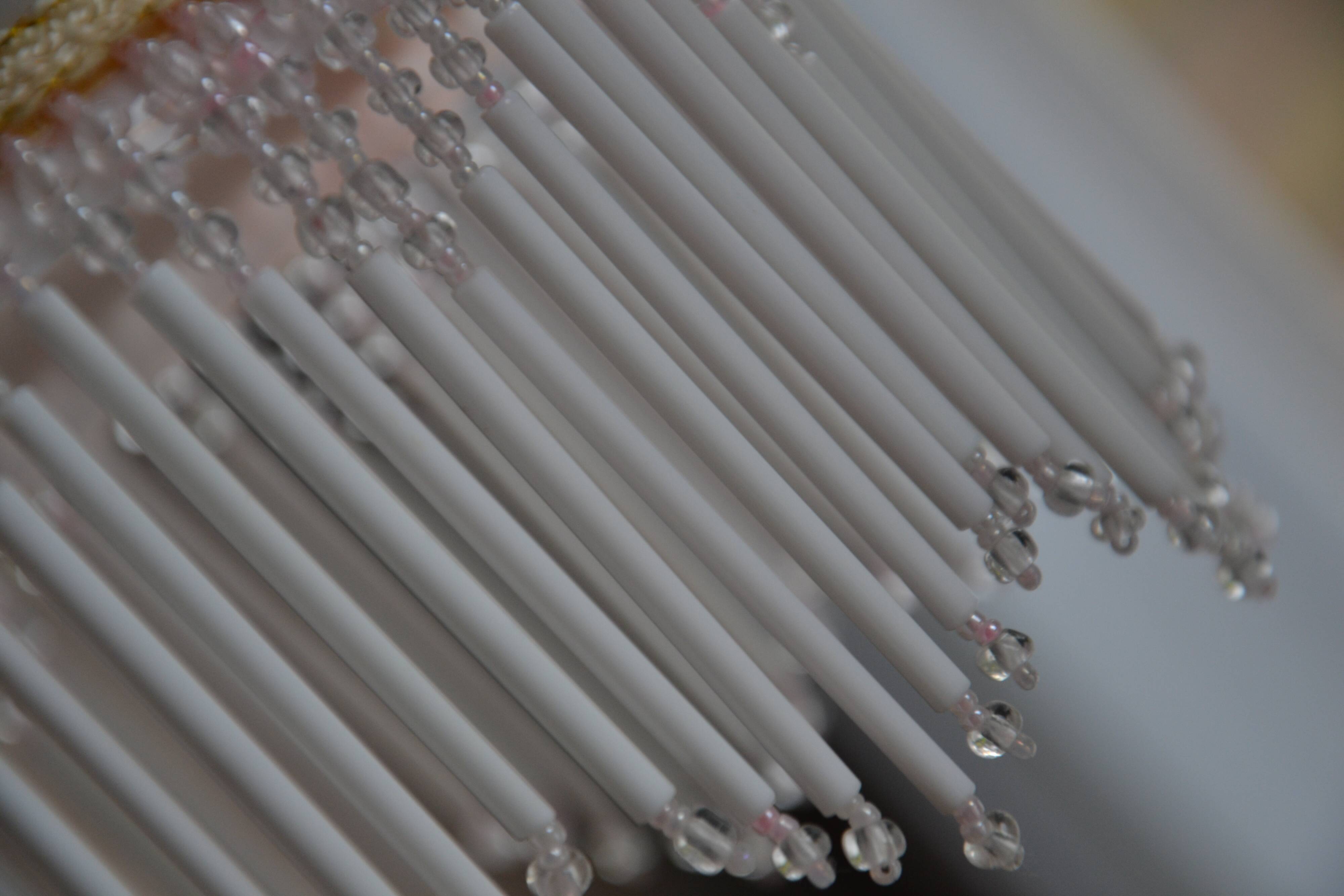 Lustrous suspension in glass paste, glass and ceramic pendants.