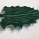 empty green ceramic pocket cup, small chips on the edges, signed