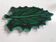 empty green ceramic pocket cup, small chips on the edges, signed