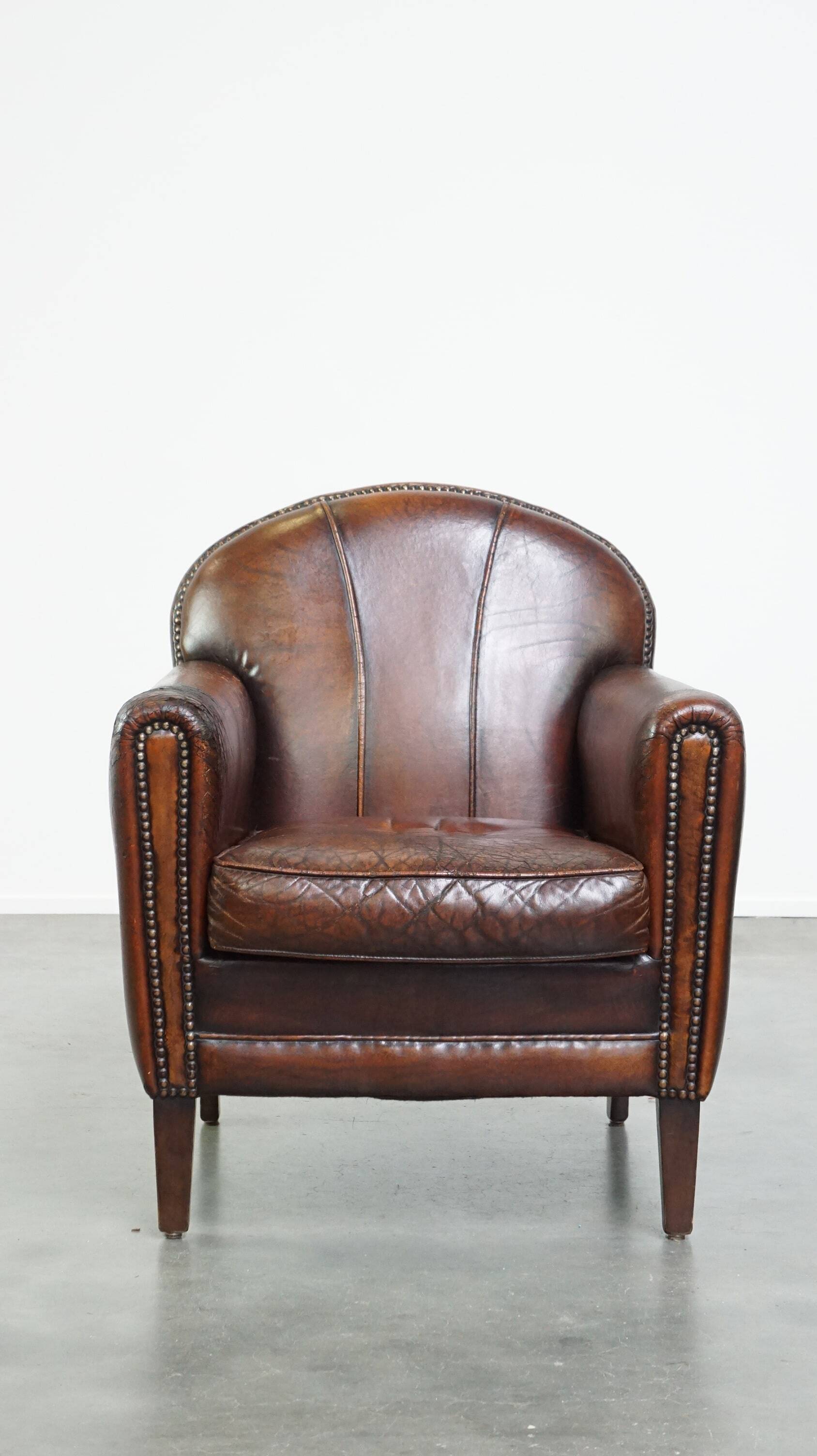 A vintage-style armchair with character, upholstered in beautifully patinated sheepskin.