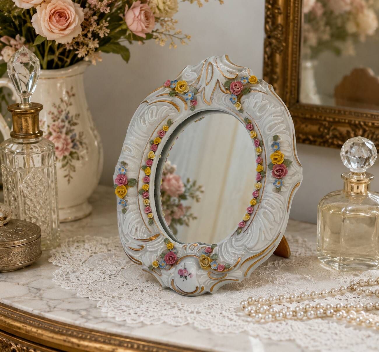 Antique porcelain mirror from Dresden with relief flowers and rococo decoration.