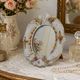 Antique porcelain mirror from Dresden with relief flowers and rococo decoration.