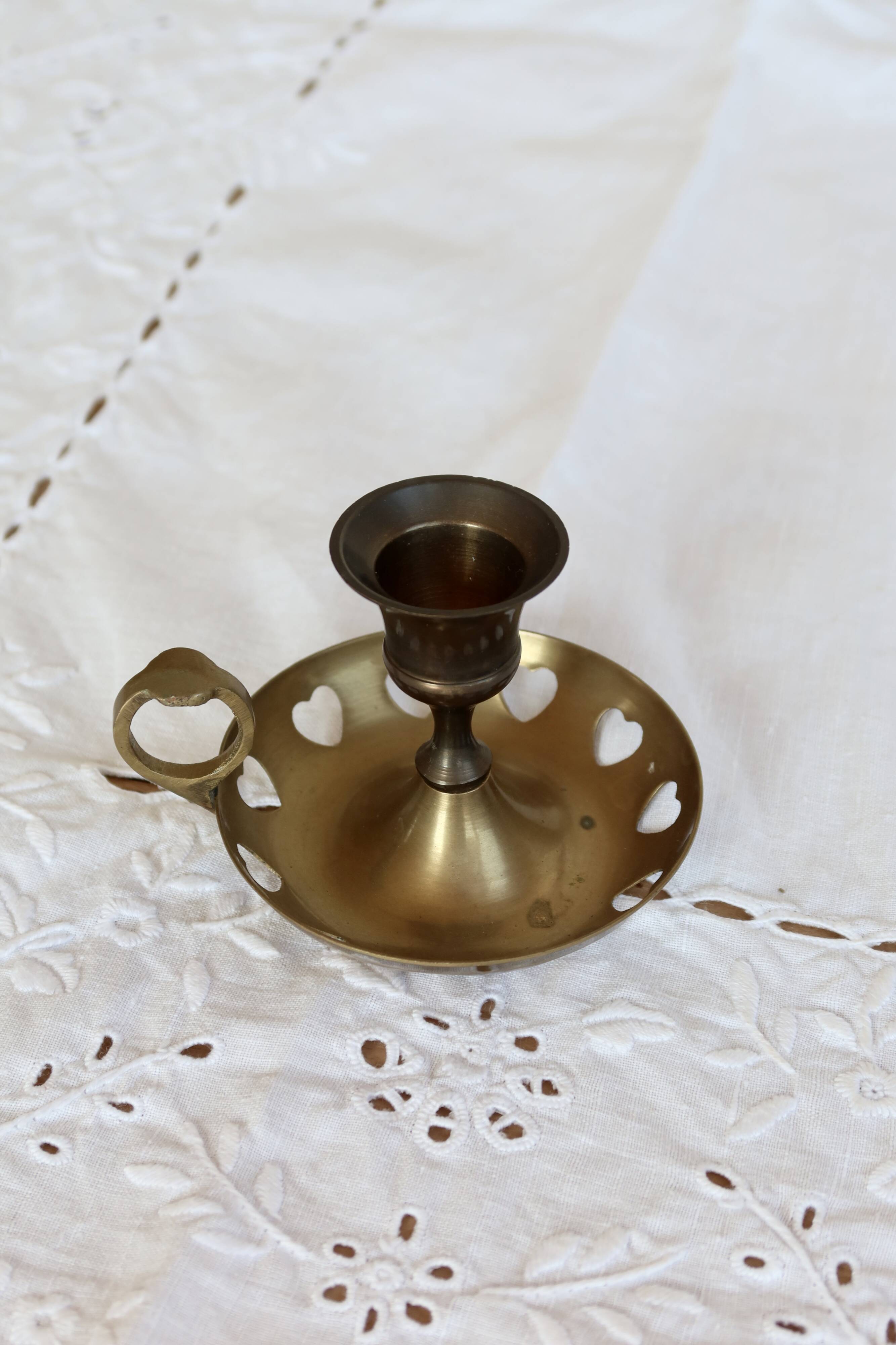 Antique brass rat trap with heart patterns.