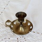 Antique brass rat trap with heart patterns.