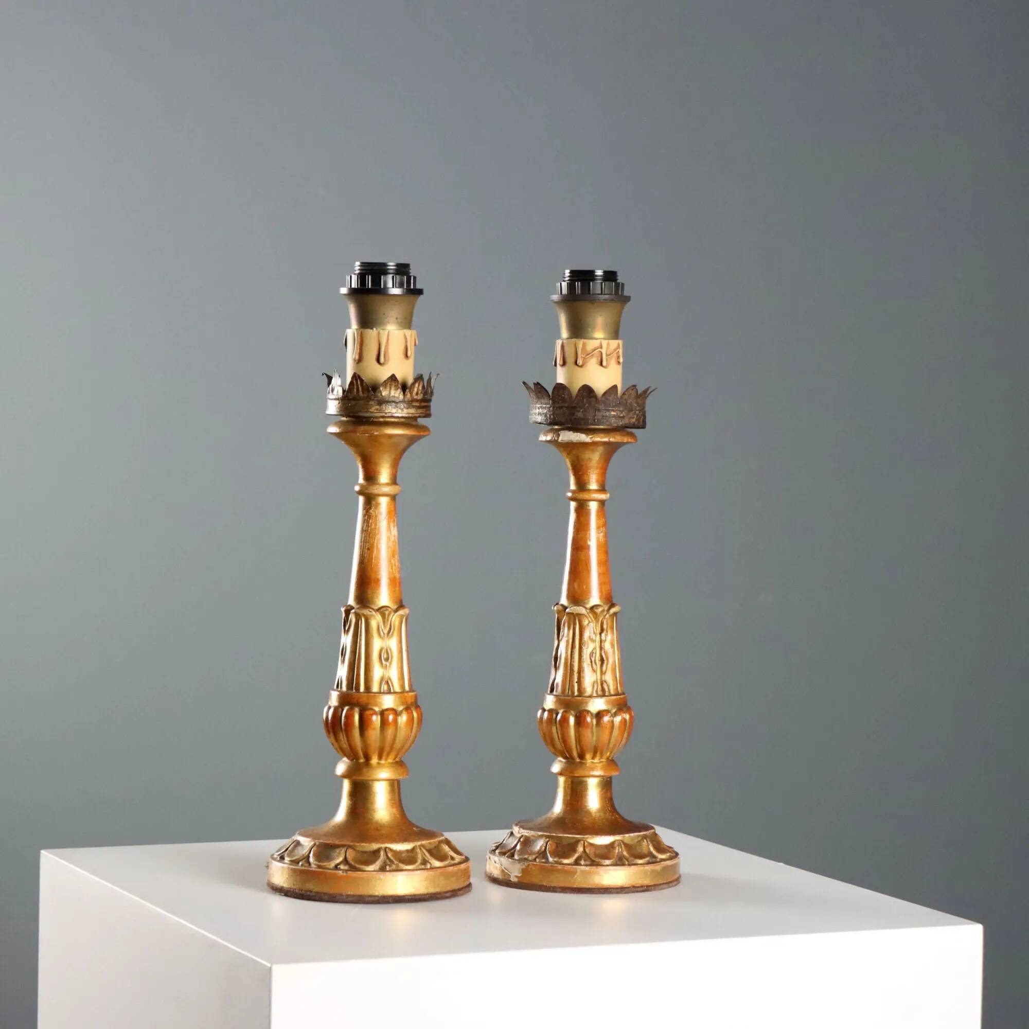 Pair of antique carved and gilded wooden candlesticks, Italy, 19th century.