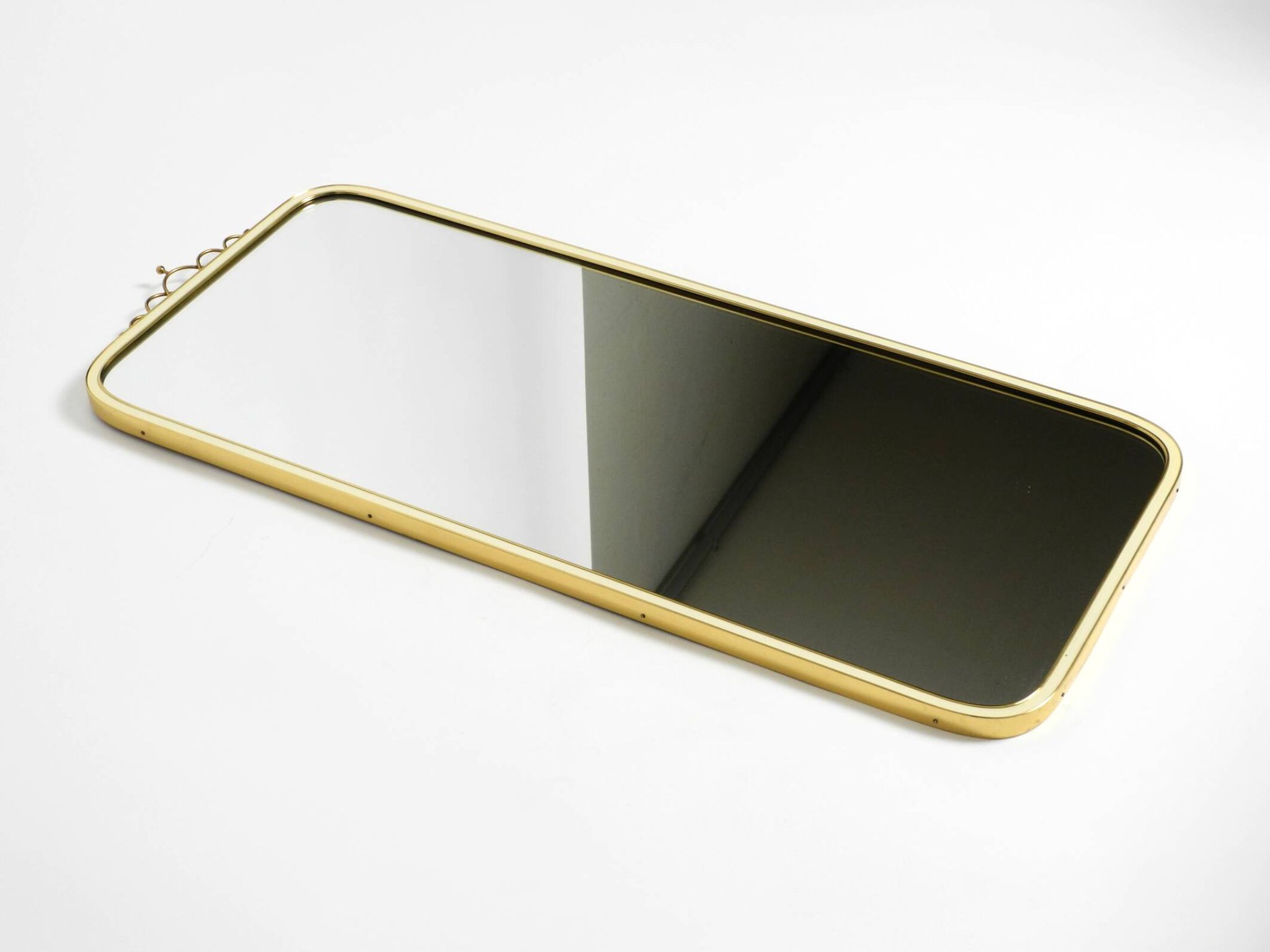 Large heavy long Mid Century brass wall mirror by Münchner Zierspiegel